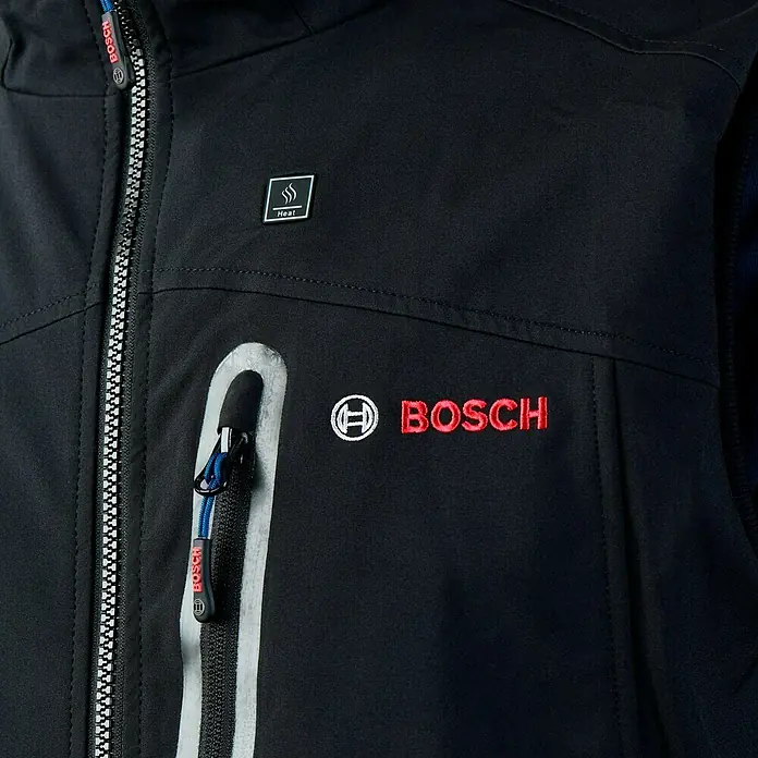 Bosch Professional Arbeitsweste GHV beheizbar - 4 -tlg., Akkuspannung: 12 V, L - Nahaufnahme einer schwarzen Bosch-Jacke mit Reißverschluss, Logo und "Heat"-Symbol für ein beheizbares Produkt.