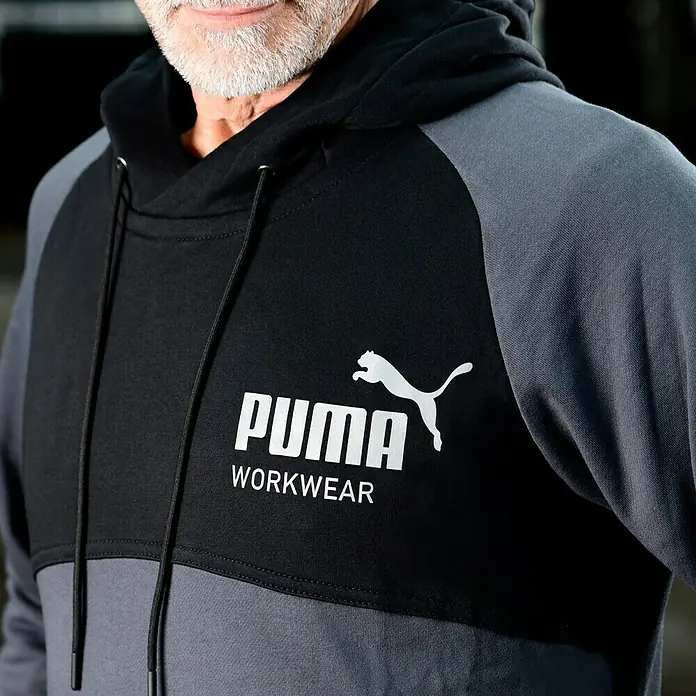 Puma Workwear Kapuzenpullover Champ - Stahlgrau, Carbon, Größe: S - Grauer und schwarzer Puma-Kapuzenpullover mit weißem Logo.