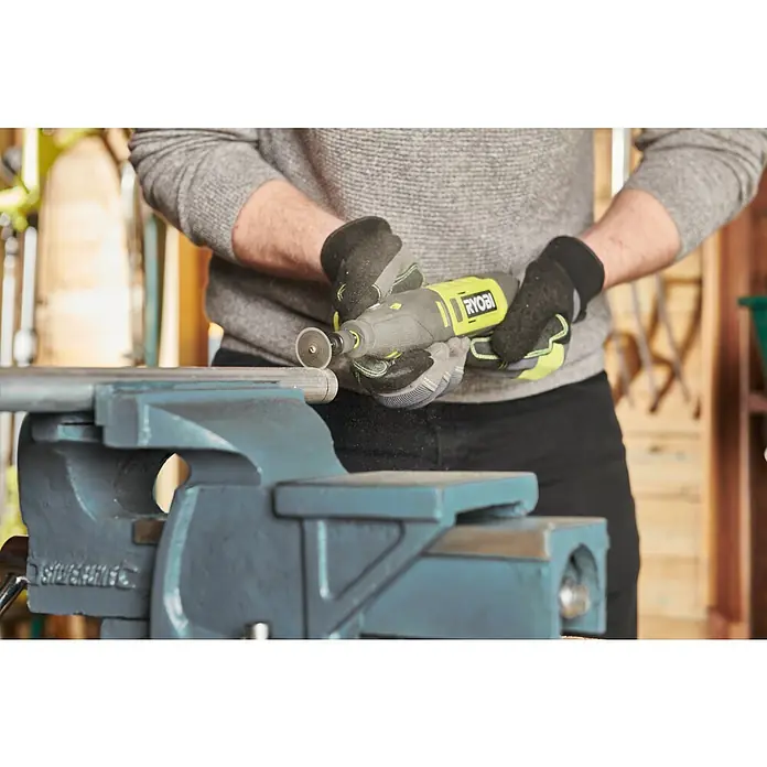 Ryobi Akku-Rotationswerkzeug RRT12-120BA335 - 12 V, 1 Akku, 2 Ah - Mann, der mit einem Ryobi-Rotationswerkzeug ein Metallrohr bearbeitet, das in einem Schraubstock befestigt ist.