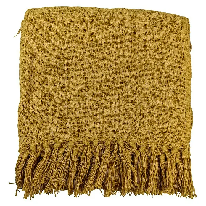 Decke Kent - Golden Yellow, 170 x 130 cm, 100 % Baumwolle - Nahaufnahme einer ockergelben Überwurfdecke mit Fransen, die eine gemütliche Textur und Wärme für jedes Zuhause bietet.
