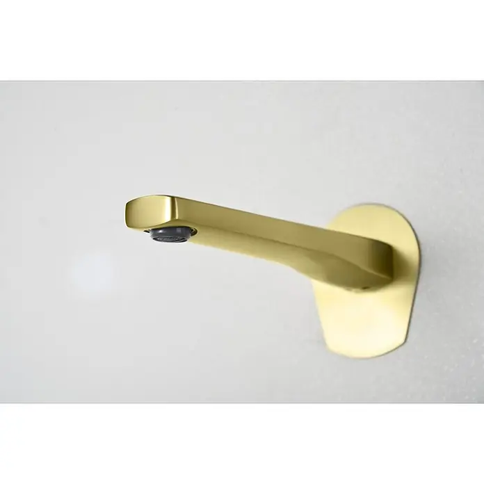 Imex Delos Grifo de lavabo - Oro - Primer plano de un elegante grifo de baño dorado montado en una pared blanca, mostrando su moderno diseño y elegante accesorio.