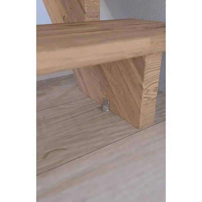 Starwood Raumspartreppe Lindos - Breite: 100 cm, Eiche, Geschosshöhe: 300 cm, Gerade, Montageseite Geländer: Wahlweise links/rechts, Designgeländer Holz/Holz, Ohne Setzstufen - Detailaufnahme einer hölzernen Treppenstufe, befestigt mit einem stabilen, silberfarbenen Winkel am Boden, der für zusätzliche Stabilität sorgt.