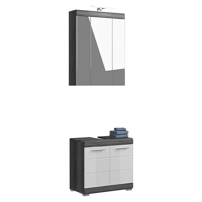 xonox.home Scout Badmöbel-Set Scout - 60 cm, Weiß/Rauchsilber, Glänzend, Mit Beleuchtung, 2 Türen - Ein Badezimmerschrank mit weißen Schubladen und Ablagefläche, darauf gestapelte blaue Handtücher und darüber ein Spiegelschrank mit Beleuchtung.