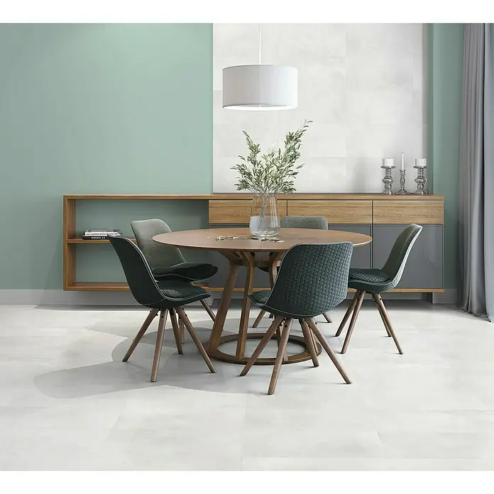Revestimiento de pared Energy - 60 x 30 cm, Blanco, Mate, Espesor: 8 mm - Una elegante mesa de comedor con cuatro sillas en una habitación amueblada de forma moderna. La mesa es de madera y las sillas están tapizadas.