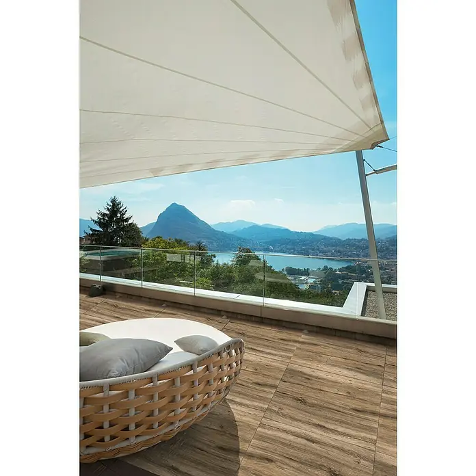 Terrassenfliese Strobus - 60 x 60 x 2 cm, Oak/Braun, Matt - Terrasse mit Outdoor-Lounge-Möbeln und Blick auf einen See, der zum Entspannen einlädt. Die Holzfliesen ergänzen die natürliche Umgebung perfekt.