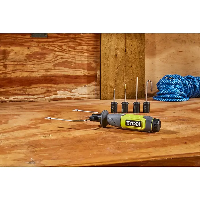 Ryobi 4V USB Akku-Heißdrahtschneider RHC4 - 4 V, 1 Akku, 2 Ah - Ryobi Heißschneider mit verschiedenen Aufsätzen auf einer Werkbank.