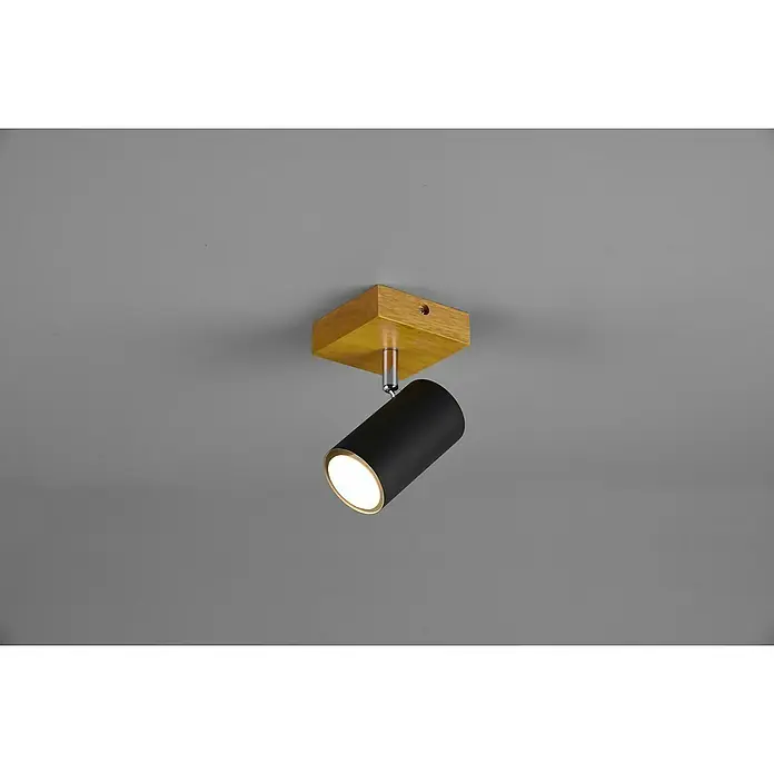 Trio Leuchten Marley Deckenstrahler - 15 W, L x B x H: 12 x 9 x 16 cm, Schwarz, GU10, 1 Stk. - Nahaufnahme einer modernen Deckenleuchte mit Holzfuß und schwarzem, zylindrischem Lampenkopf, die warmes Licht spendet.