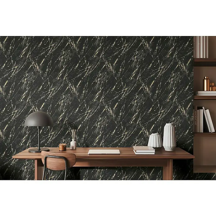 A.S. Création Casual Living Vliestapete MarmorSchwarz/Gold/Metallic, Steinoptik, 10,05 x 0,53 m - Schwarze Marmortapete mit goldenen Akzenten als Hintergrund für einen Schreibtisch mit Deko.