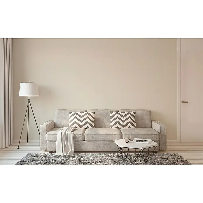 A.S. Création Casual Living Vliestapete - Cremefarben, Uni, 10,05 x 0,53 m - Einladendes Wohnzimmer mit grauem Sofa, Zickzack-Kissen, Stehlampe und modernem Couchtisch, ideal für entspannte Stunden.