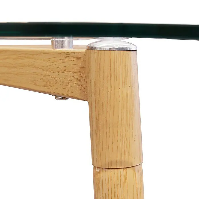 Mesa de comedor Cristal - L x An x Al: 75 x 115 x 75 cm, Transparente - Primer plano de una elegante mesa de cristal con estructura de madera clara y conectores plateados.