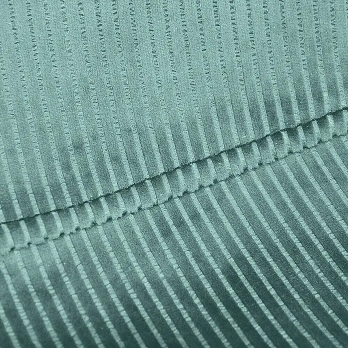 Silla Giulia - Azul, 4 pzs. - Primer plano de una tela de pana verde azulado con una costura. La tela presenta una textura fina y acanalada.