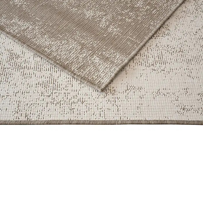 Alfombra exterior reversible Antique - Beige, 230 x 160 cm, Polipropileno - Primer plano de una alfombra de color claro con un patrón abstracto y textura visible.