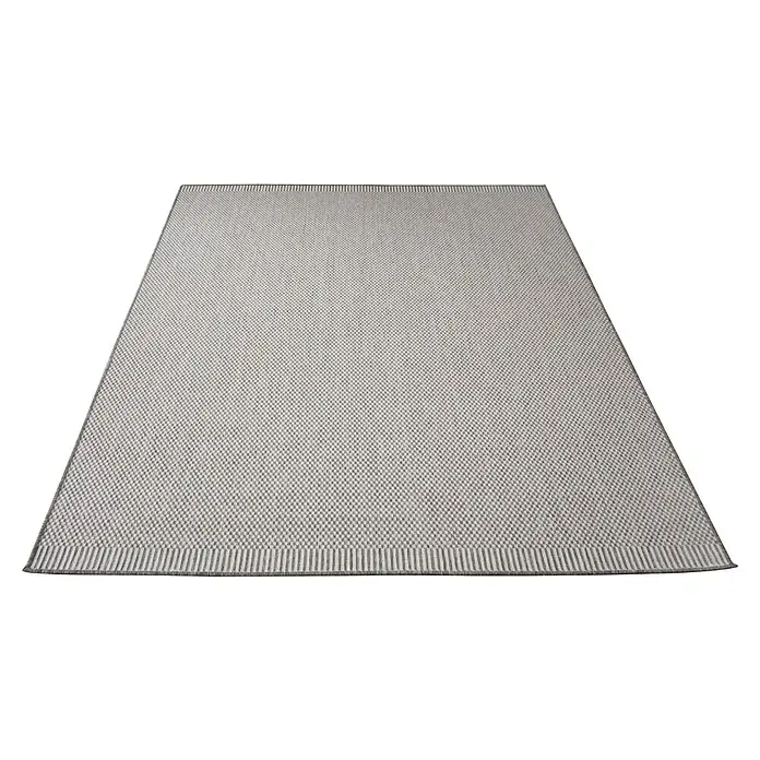 Alfombra exterior reversible Vichy - Gris, 170 x 120 cm, Polipropileno - Una alfombra rectangular con un sutil patrón tejido yace plana, mostrando su textura y combinación de colores neutros.