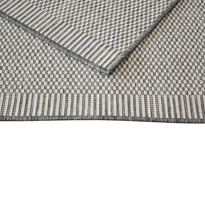 Alfombra exterior reversible Vichy - Gris, 170 x 120 cm, Polipropileno - Primer plano de una alfombra de exterior gris con borde y textura tejida, ideal para añadir estilo y durabilidad a espacios exteriores.