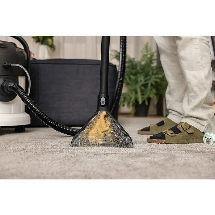 Kärcher Waschsauger SE 4 - 1.000 W, Behältervolumen: 4 l - Nahaufnahme eines schmutzigen Teppichreinigers, der auf einem Teppich verwendet wird, der Schmutz und Seifenlauge enthält.
