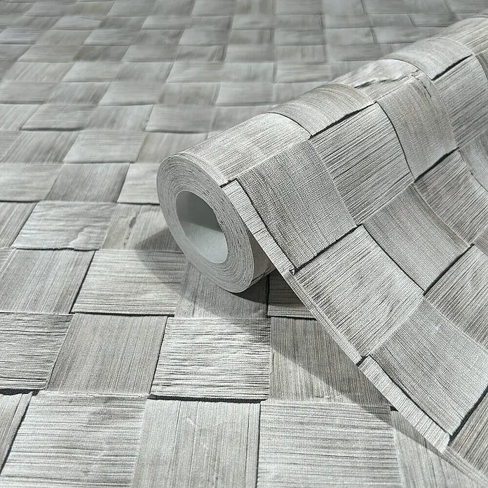 Marburg Struktura Vliestapete 3D-Geflecht - Grau, 3D-Optik, 10,05 x 0,53 m - Nahaufnahme einer Rolle grauer Vinyltapete mit einem gewebten quadratischen Muster, das eine elegante und moderne Wanddekoration bietet.