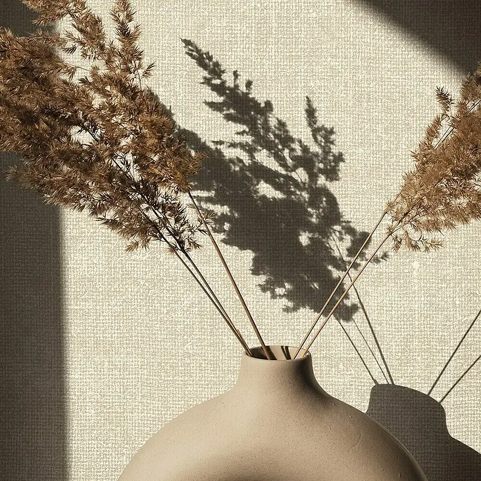 Marburg Struktura Vliestapete Struktur - Beige, Uni, 10,05 x 0,53 m - Nahaufnahme einer stilvollen, beigen Keramikvase mit getrockneten Blumen, die ein warmes, natürliches Ambiente erzeugt.