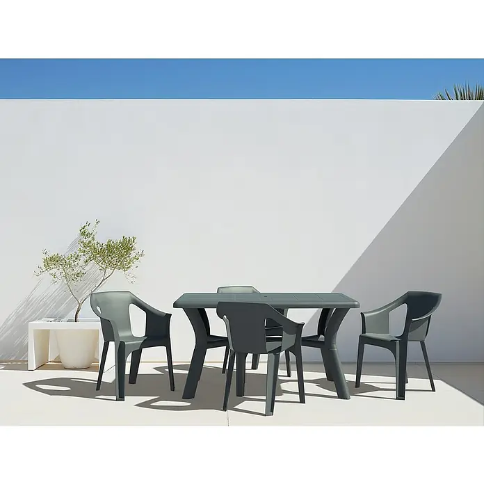 Mesa de jardín Tulipan - L x An x Al: 140 x 90 x 74 cm, Polipropileno, Antracita - La imagen muestra un conjunto de mesa de jardín gris con cuatro sillas en una terraza frente a una pared blanca.