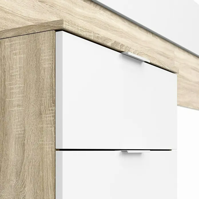 Cabecero de cama con mesitas Alaya - Roble Canadian/Blanco Artik, 3 pzs. - Primer plano de un armario con cajones blancos y un acabado de madera clara, que desprende una estética moderna.