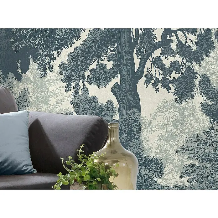 Komar Pure 2 Fototapete Unfading Trees - B x H: 400 x 250 cm, Vlies - Nahaufnahme eines Zimmers mit einer Couch, einer goldenen Flasche und einer Topfpflanze vor einer Tapete mit Waldmotiv.