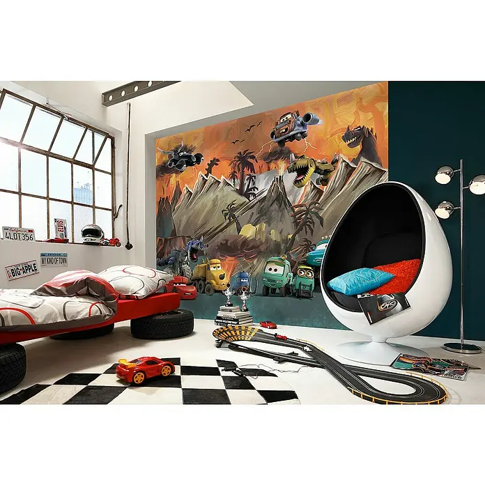 Komar Fototapete Disney Cars Carosaurus - B x H: 300 x 250 cm, Vlies - Kinderzimmer mit Autobett auf Reifen und einer Egg Chair Sitzgelegenheit, dekoriert mit einem coolen Dino-Cars Wandbild.