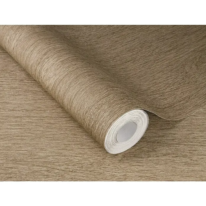 SCHÖNER WOHNEN-Kollektion Cosyliving Vliestapete WOOD Holz-Allover - Braun, Holzoptik, 10,05 x 0,53 m - Nahaufnahme einer Rolle Holzfurnier-Tapete. Die Textur und Farbe des Holzes sind deutlich sichtbar, ideal für Innendesign-Projekte.