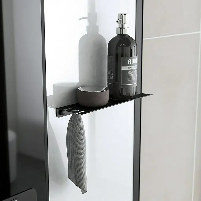 Aurlane Cabina de ducha de vapor Relax Hammam - 90 x 115 x 215 cm, Negro - Un estante de baño negro con una botella, un recipiente y una toalla, que combina funcionalidad con un estilo elegante para la decoración del baño.