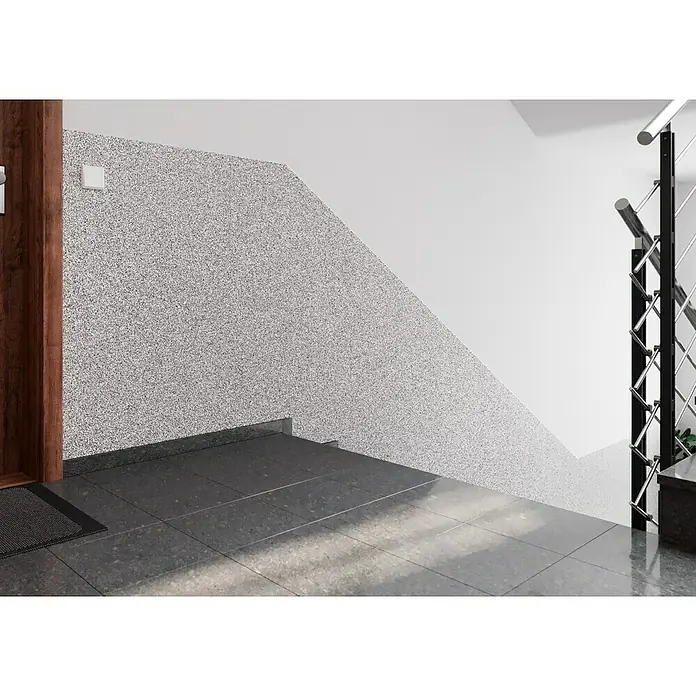 Probau WDVS-Buntsteinputz - Weiß/Schwarz, 25 kg - Eine Innenaufnahme eines Flurs mit Terrazzoboden und Treppe. Der Terrazzo erstreckt sich an der Wand entlang der Treppe und schafft so ein modernes Design.