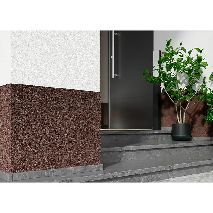 Probau WDVS-Buntsteinputz - Weiß/Rot/Schwarz, 25 kg - Nahaufnahme einer Fassade mit auffälligem, zweifarbigen Putz und Eingangstür, akzentuiert durch eine Pflanze im Topf.