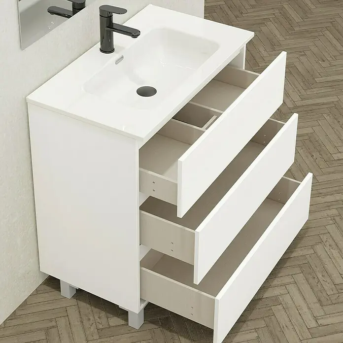 Conjunto de mueble de baño Inter - Blanco, Mate, 4 pzs. - La imagen muestra un mueble de baño blanco con tres cajones y un lavabo con grifo negro. Este mueble moderno ofrece almacenamiento.