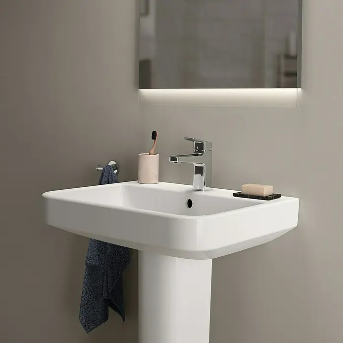 Ideal Standard i.life B Waschtisch60 x 48 cm, Ohne Spezialglasur, Hahnloch: Mitte, Mit Überlauf, Weiß - Ein modernes Waschbecken mit Armatur, Seife und Zahnbürste in einem stilvollen Badezimmer.