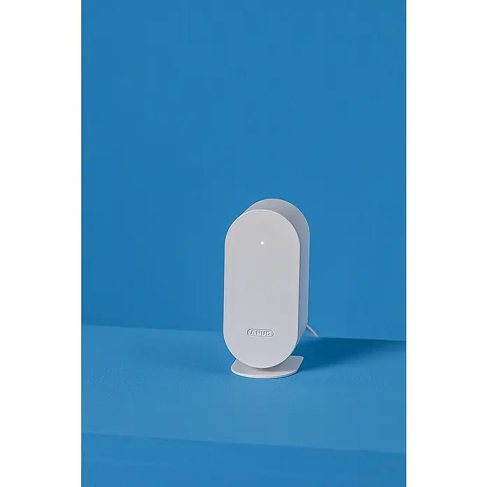 Abus Steuerzentrale BRIDGE ONE CFW3100W - Weiß, B x H: 55 x 52 mm - Weißes ABUS-Produkt auf blauem Untergrund. Kompaktes Design, ideal für Sicherheitstechnik.