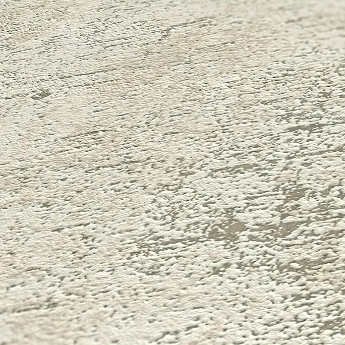 A.S. Création Jade 2 Vliestapete - Weiß-Taupe-Rosa, Uni, 10,05 x 0,53 m - Nahaufnahme einer strukturierten, hellen Oberfläche, die eine grobe Textur und subtile Farbvariationen aufweist.