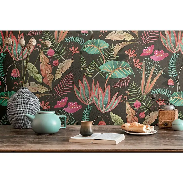A.S. Création Famous Garden Vliestapete - Schwarz-Bunt-Grün, Floral, 10,05 x 0,53 m - Stillleben mit einer türkisfarbenen Teekanne und einer alten Kaffeemühle auf einem Holztisch vor einer floralen Tapete.