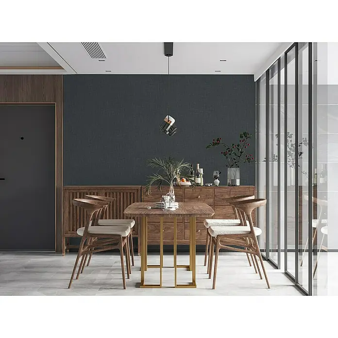 A.S. Création Stories of Life Vliestapete - Anthrazit, Uni, 10,05 x 0,53 m - Holzstühle mit Stoffbezug um einen quadratischen Holztisch mit goldenen Beinen, ergänzt durch ein Sideboard.