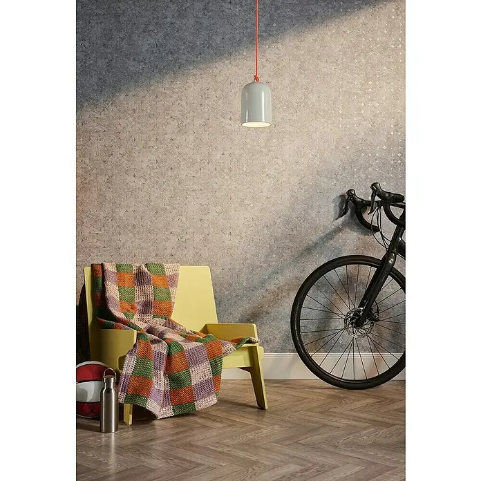 A.S. Création Stories of Life Vliestapete Used-Look - Beige-Braun, Betonoptik, 10,05 x 0,53 m - Eine stilvolle Szene mit einer Pendelleuchte, einem gelben Stuhl mit Decke und einem Fahrrad, die eine moderne Inneneinrichtung präsentieren.