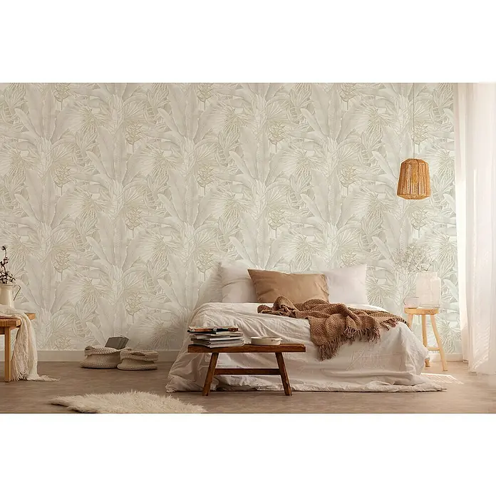 A.S. Création Stories of Life Vliestapete - Beige-Creme-Grau, Floral, 10,05 x 0,53 m - Ein Schlafzimmer mit einer dekorativen Blattmuster-Tapete, einem gemütlichen Bett und sanfter Beleuchtung, die eine ruhige und entspannende Atmosphäre schafft.
