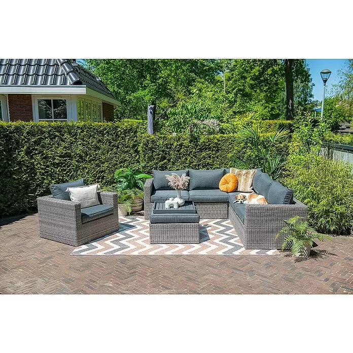 Garden Impressions Loungemöbel-Set Orangebird - 4 -tlg., Aluminium, Schwarz/Grau - Grau geflochtene Outdoor-Lounge-Gruppe mit dunkelgrauen Kissen, Ecksofa, Sessel und Couchtisch auf einer Terrasse.