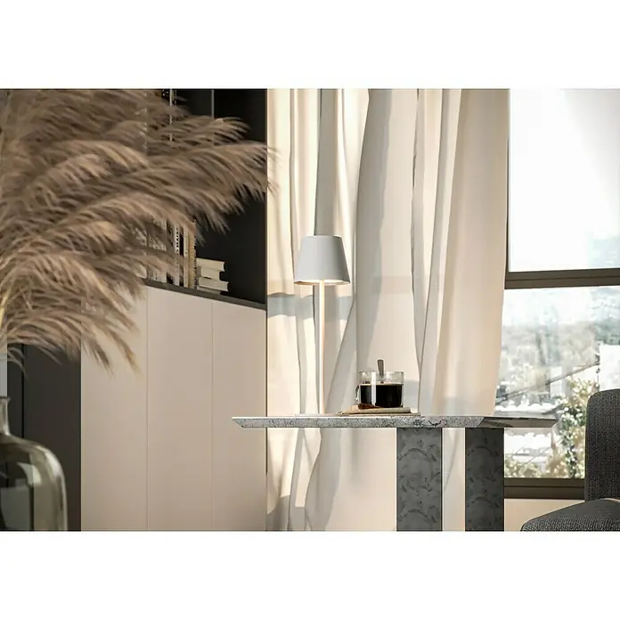 Starlux Paola Akku-Tischleuchte - 3 W, L x B x H: 11 x 11 x 36 cm, Weiß, Warmweiß - Nahaufnahme eines Tisches mit einer Tasse Kaffee und einer Lampe vor einem Fenster mit Vorhängen. Das natürliche Licht betont die Details.