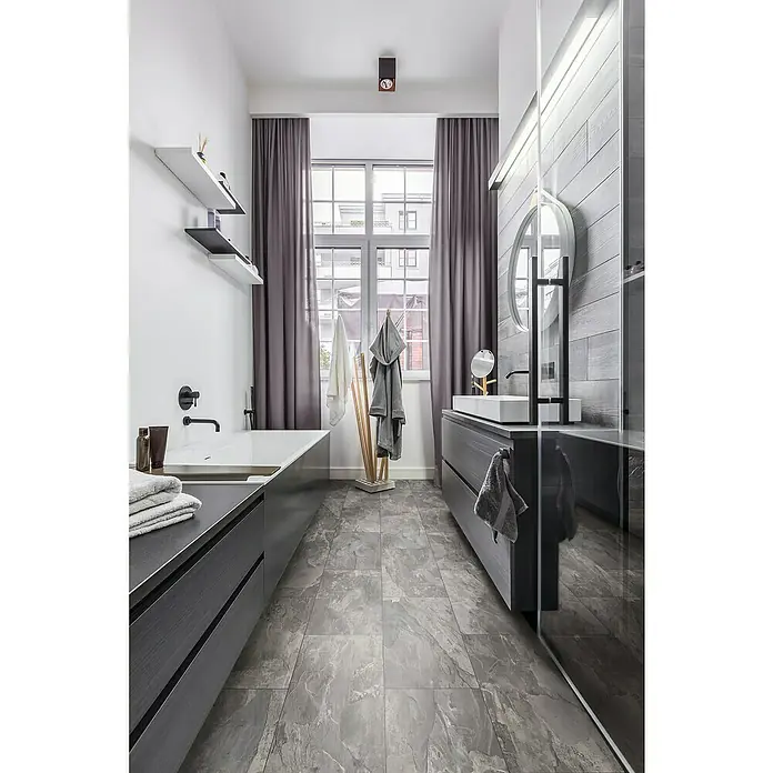 Krono Original Laminatmuster Organic Classic Silverado Slate - 297 x 330 x 8 mm, Fliesenoptik - Modernes Badezimmer mit grauen Fliesen, grauen Vorhängen und dunklen Holzmöbeln, das ein luxuriöses und stilvolles Ambiente ausstrahlt.