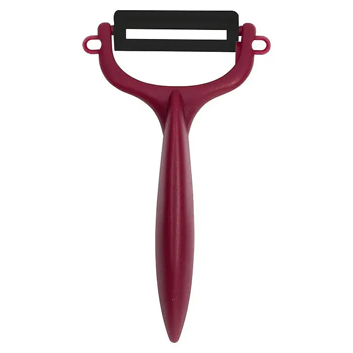 Pelador de verduras - Hoja de cerámica, Beige/Blanco/Negro/Gris/Burdeos, 1 pzs. - Primer plano detallado de un pelador de verduras rojo con una hoja negra sobre un fondo negro. Una práctica herramienta de cocina.