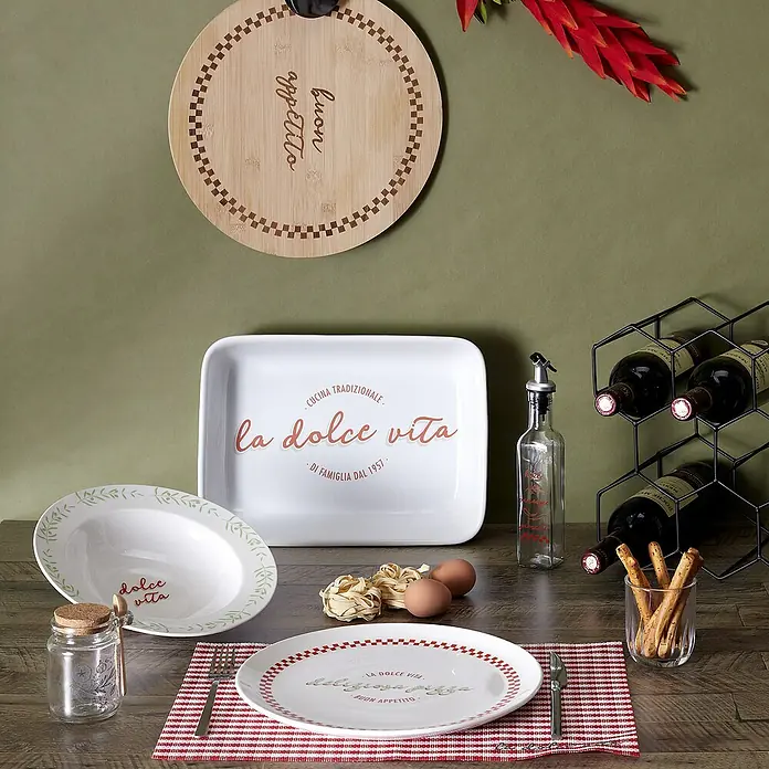 Aceitera y vinagrera - 250 ml, Vidrio, 1 pzs. - Un arreglo de vajilla "La dolce vita" con decoraciones, incluyendo platos, tazones, una fuente para servir y una botella de aceite.
