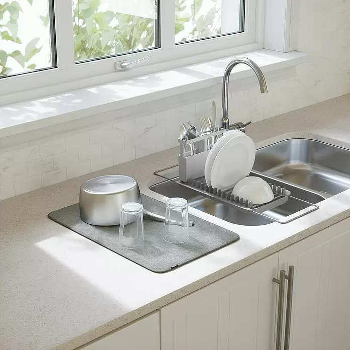 Umbra Abtropfmatte Udry - L x B x H: 51 x 57 x 17 mm, Kunststoff, Grau - Graue Geschirrabtropfmatte mit Topf und Gläsern neben einer Küchenspüle.