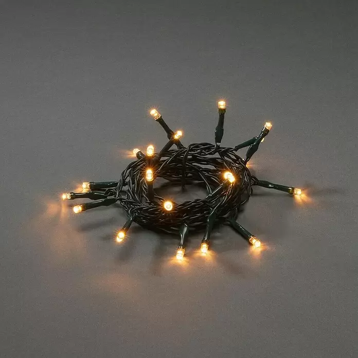 Konstsmide LED-Lichterkette - Innen, Lichtfarbe: Bernstein, Anzahl Leuchtmittel: 20 Stk. - Aufgewickelte dunkelgrüne LED-Lichterkette mit warmweißem Leuchten.