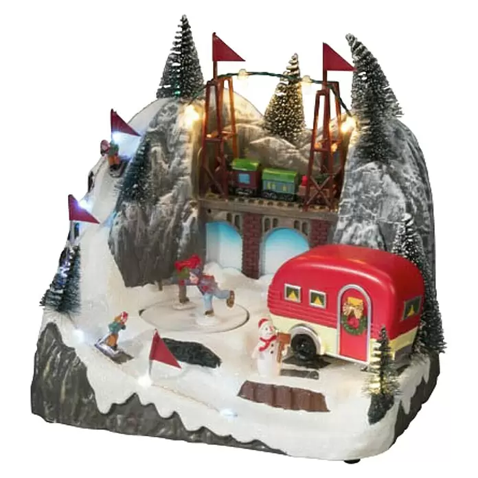 Konstsmide LED-Szenerie Caravan - L x B x H: 16 x 22 x 21,5 cm, Bunt, Batteriebetrieben, LED - Animierte Winter-Weihnachtsdorf-Szene mit Zug auf Brücke, Eisläufern und Wohnwagen, mit LED-Lichtern beleuchtet.