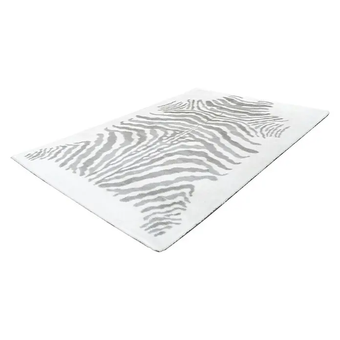 Kayoom Hochflorteppich Zebra - Weiß/Grau, 230 x 160 cm, 100 % Polyester - Ein rechteckiger Teppich mit einem grauen Zebra-Muster auf weißem Grund. Ein auffälliger Teppich für moderne Wohnräume.