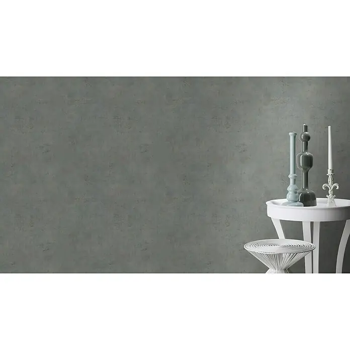 Rasch Vliestapete Beton - Dunkelgrau, Betonoptik, 10,05 x 0,53 m - Stillleben mit dekorativen Vasen und einer Kerze auf weißen Beistelltischen vor einer grauen Wand.