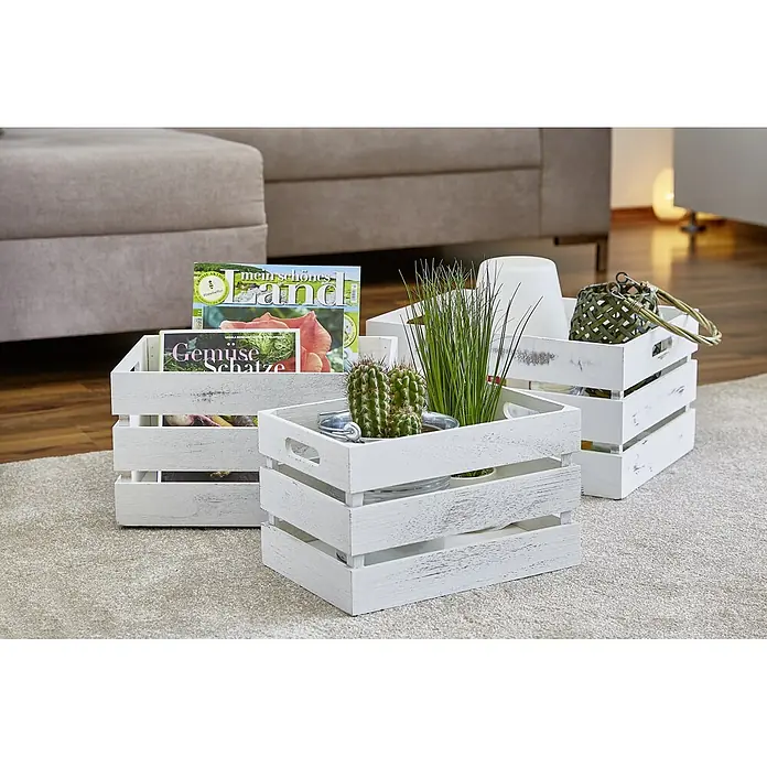 Zeller Present Holzkiste - L x B x H: 31 x 21 x 18,7 cm, Weiß - Drei weiße Holzkisten auf einem Teppich, dekoriert mit Zeitschriften, einem Kaktus, Kunstgras, einer Lampe und einer Handtasche.
