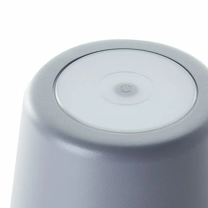 Brilliant Akku-Tischleuchte Kaami - 2 W, Grau, Warmweiß - Nahaufnahme einer grauen Lampe mit einem runden, weißen Lichtknopf oben drauf.