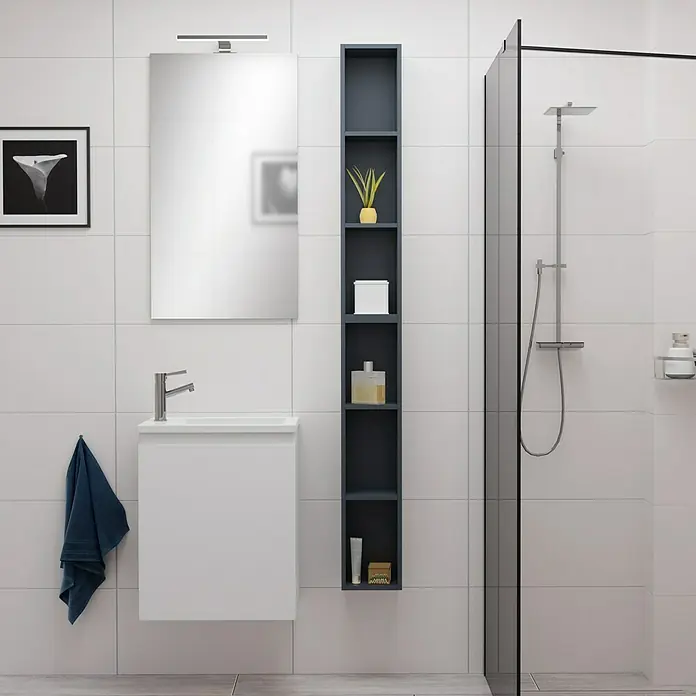 Camargue Espacio Badmöbel-Set F2 - 70 cm, Gama weiß matt - Modernes Badezimmer-Interieur mit Waschbeckenunterschrank, Spiegel, Regal und Dusche vor weißen Fliesen.